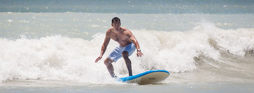 Charleston surf lessons guest catches a wave. © 2014 Audra L. Gibson Studios. All Rights Reserved.