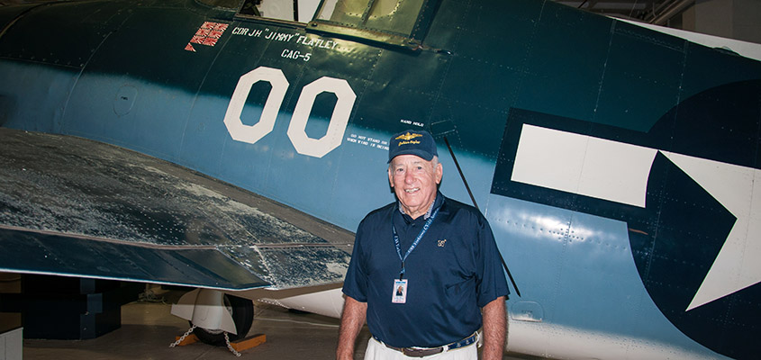 RADM James Flatley poses with one of his father's planes from WWII. © 2016 Audra L. Gibson. All Rights Reserved.