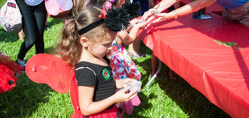 Volunteers distribute ladybugs to children to release into the gardens. © 2016 Audra L. Gibson