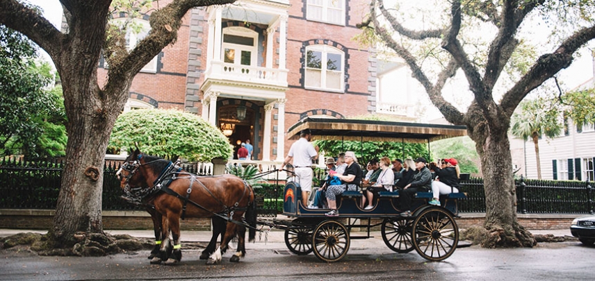 Carriage tour guests learn about the Calhoun mansion on a residential tour of the historic district.